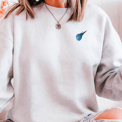 Stained glass style Final Fantasy meteor logo on a white sweater.